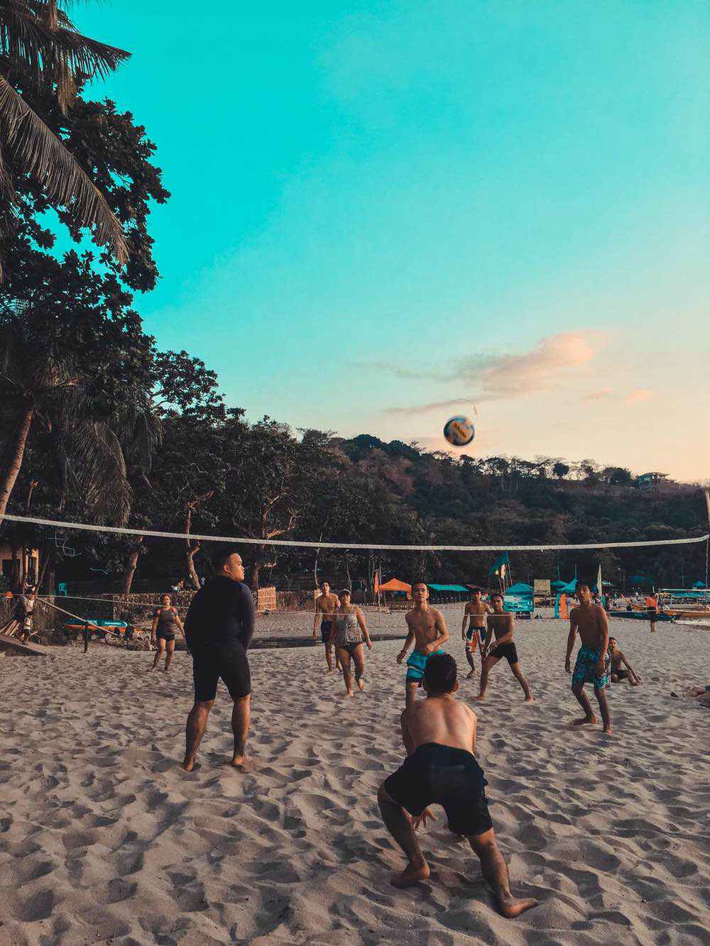 People playing volleyball in the afternoon on the beach 